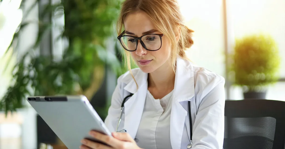 Behavioral health clinician reviewing compliance documentation in a calm office setting